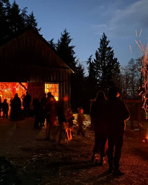 Families gathered around a bonfire at the Nature Academy